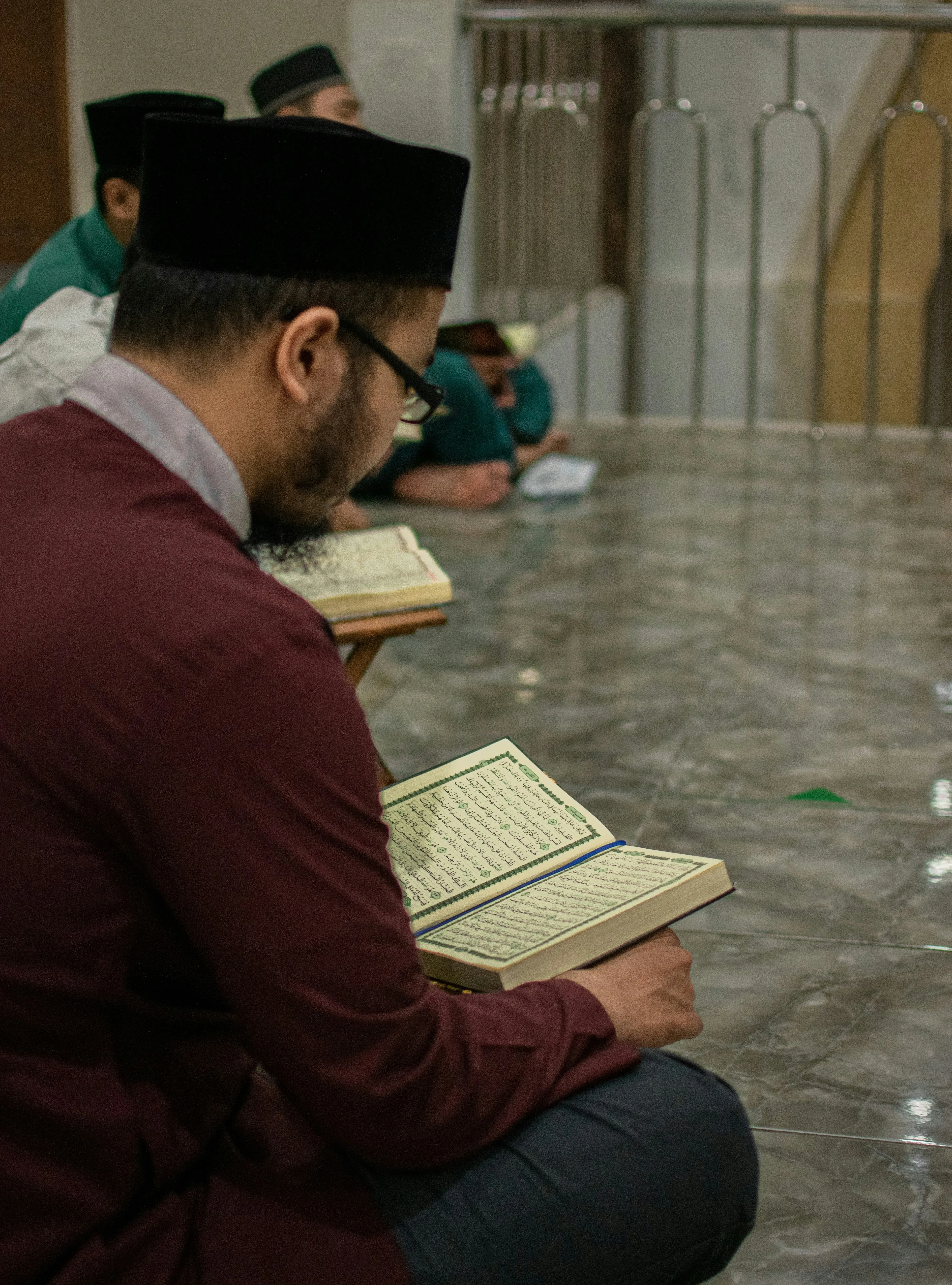 Picture of people reading Holy Quran